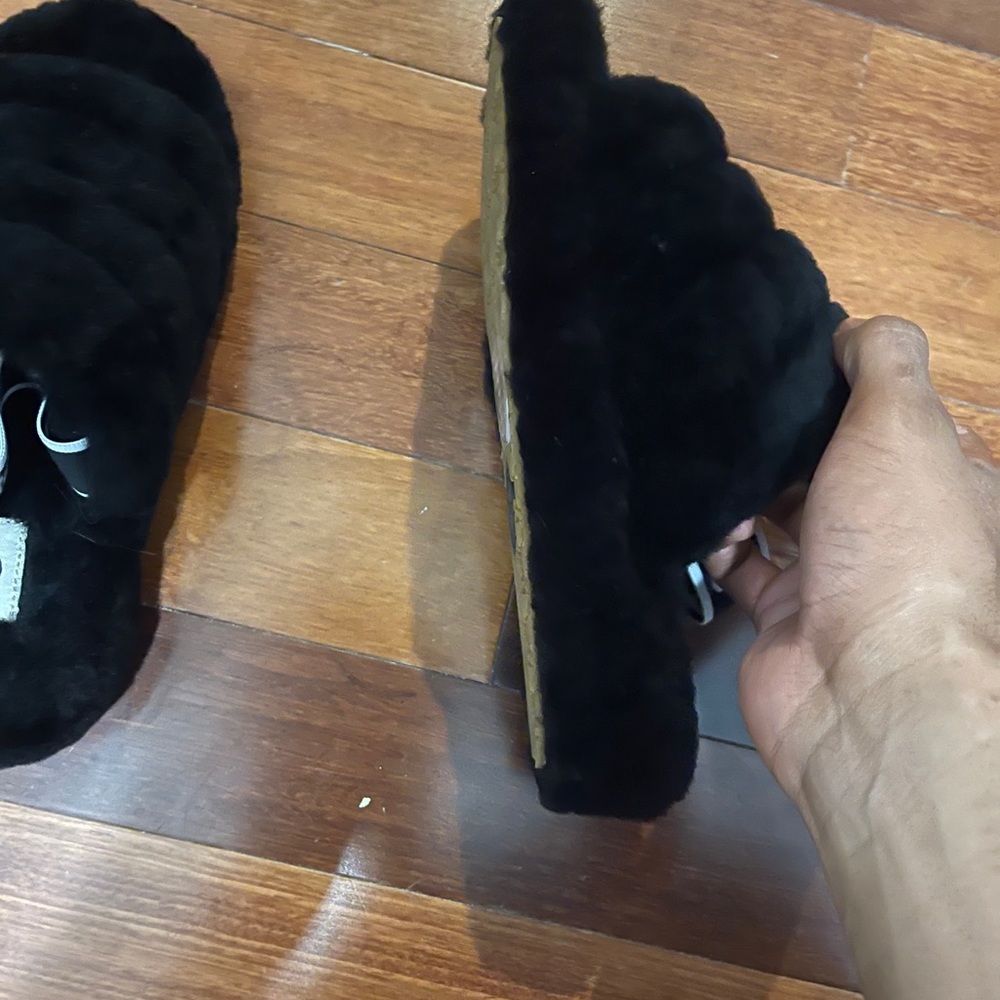 Woman’s Ugg’s black slippers